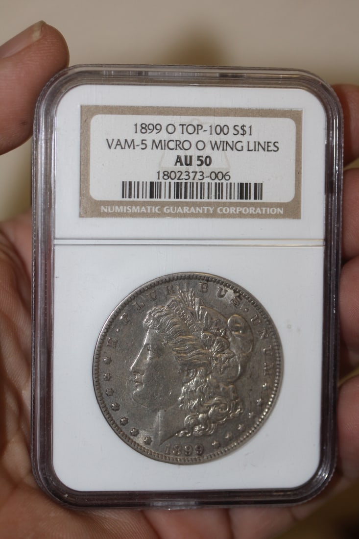 NGC Graded 1899-O Morgan Silver Dollar: AU50 Top 100 - VAM-5 micro-O wing lines - considered a mint error coin