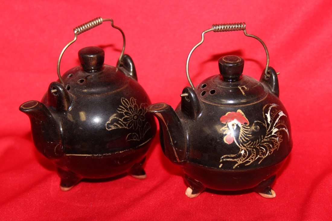 Set of Two Salt and Pepper Shakers: please note: one has couple of small chips on the legs - approximately 3 1/2" tall each