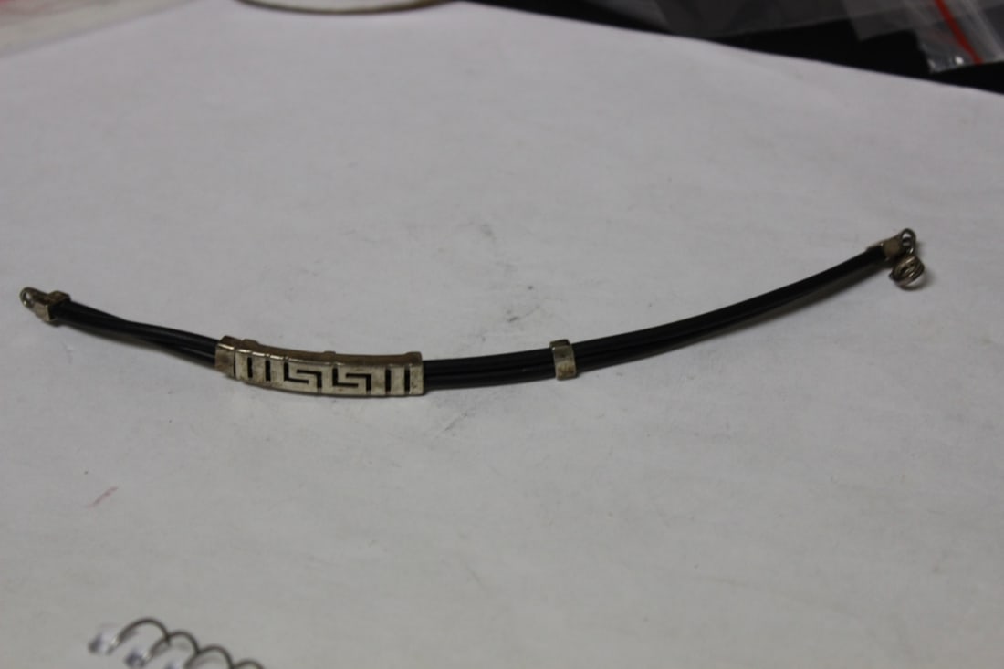 A Sterling and Leather Bracelet: Approximately 7" long - good design