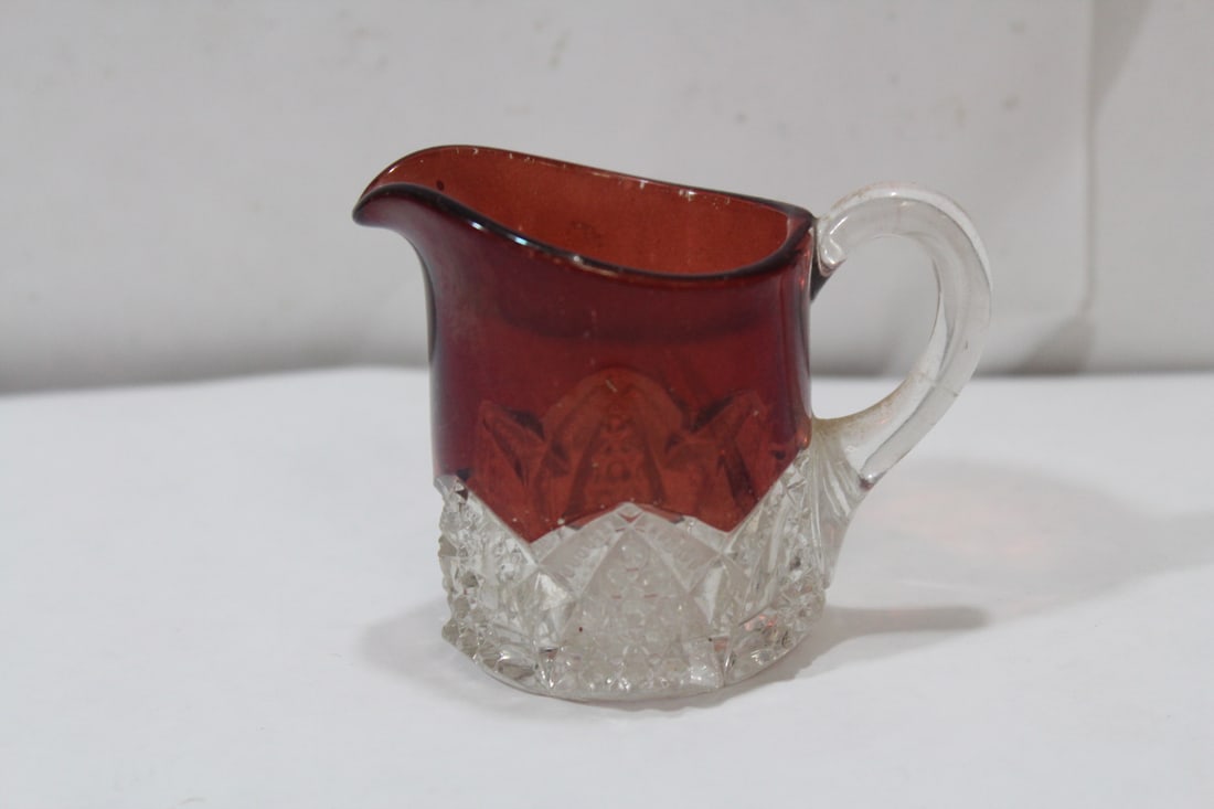 A Small Glass Pitcher: cranberry or amber color - 2 3/4" tall