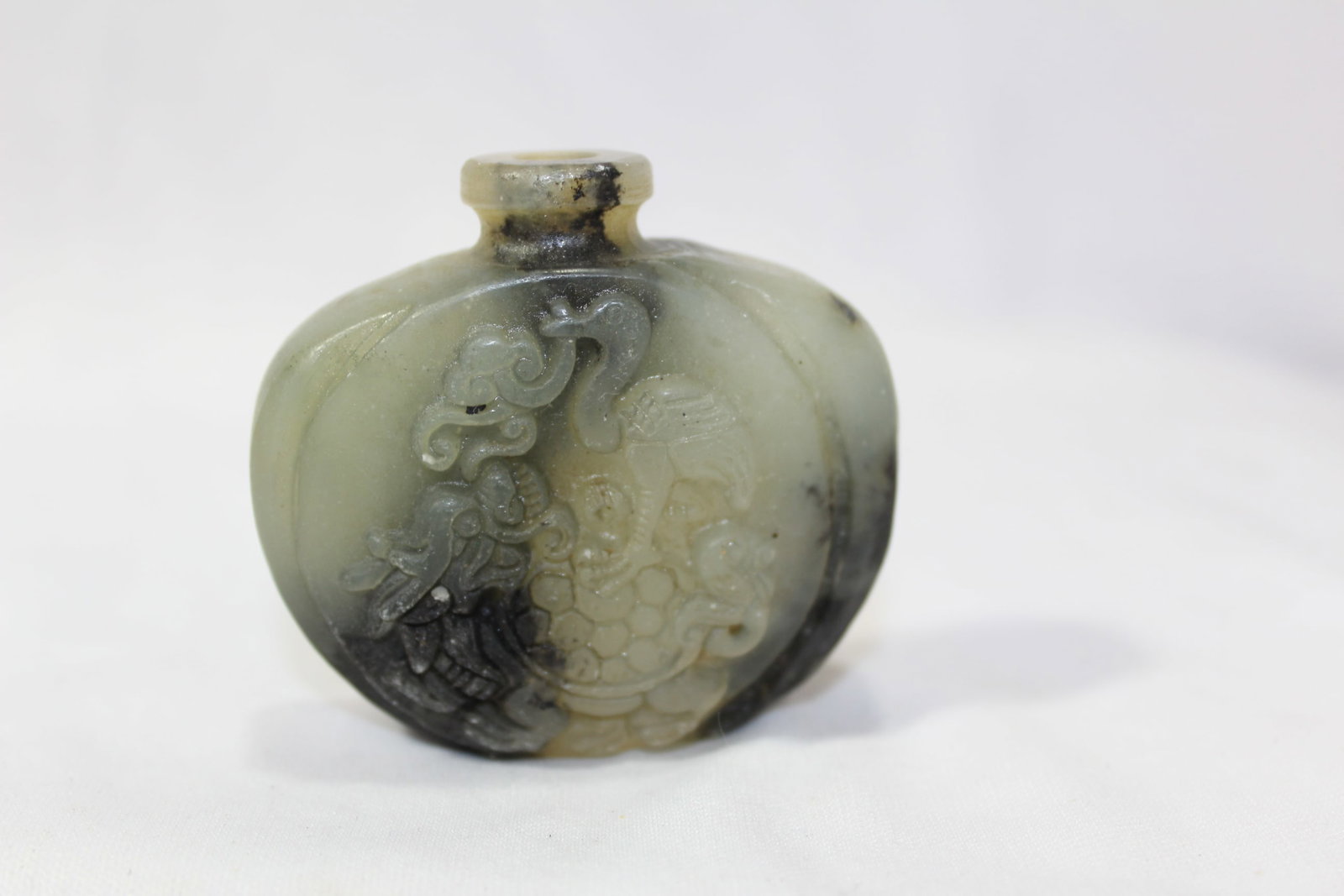 A Jade Snuff Bottle: 2 1/8" tall - no stopper - carved on one side