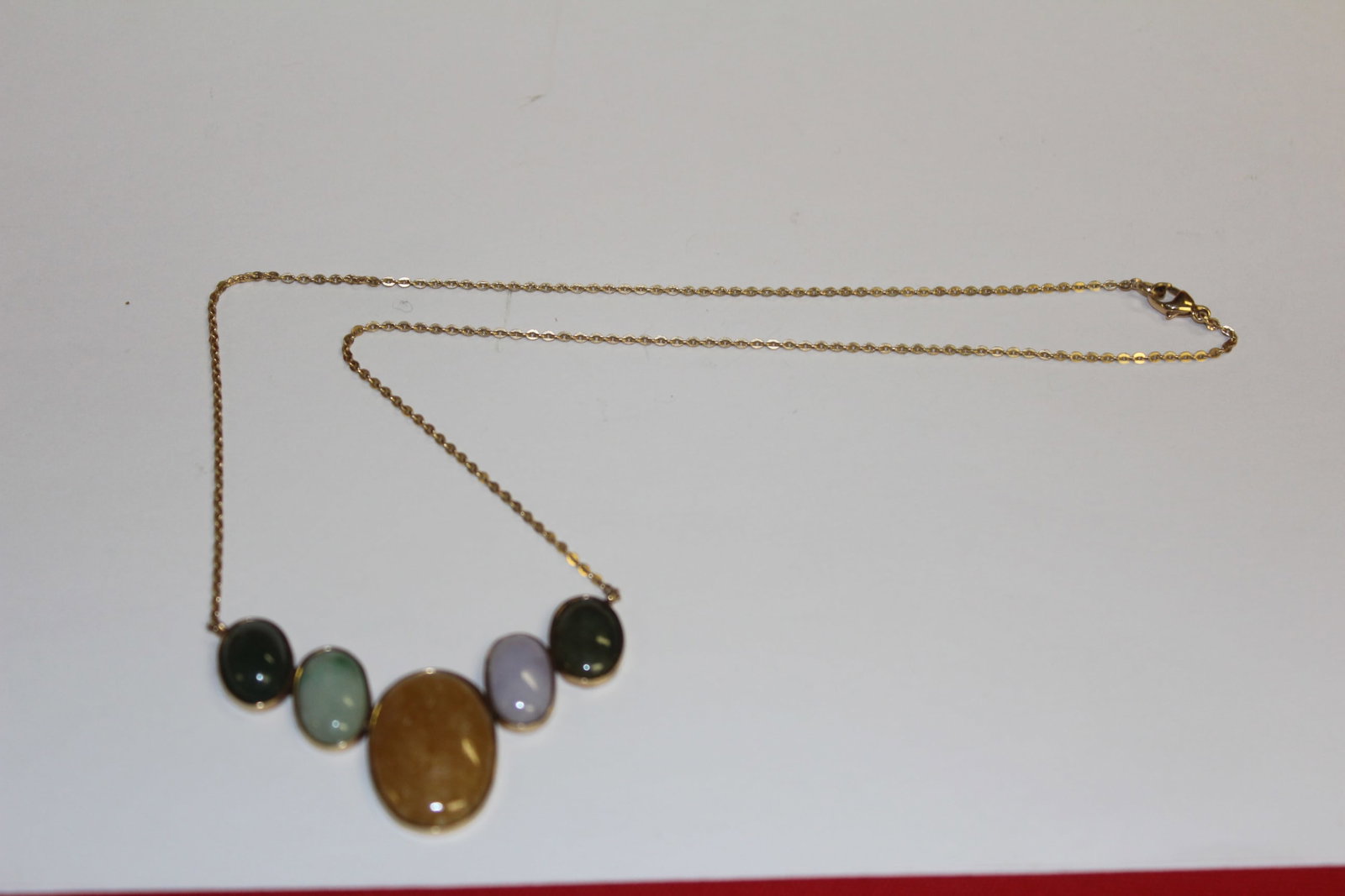 14k Gold Jade Pendant: 9" long when clasped. 11.1 grams. Unmarked but tested as 14k.