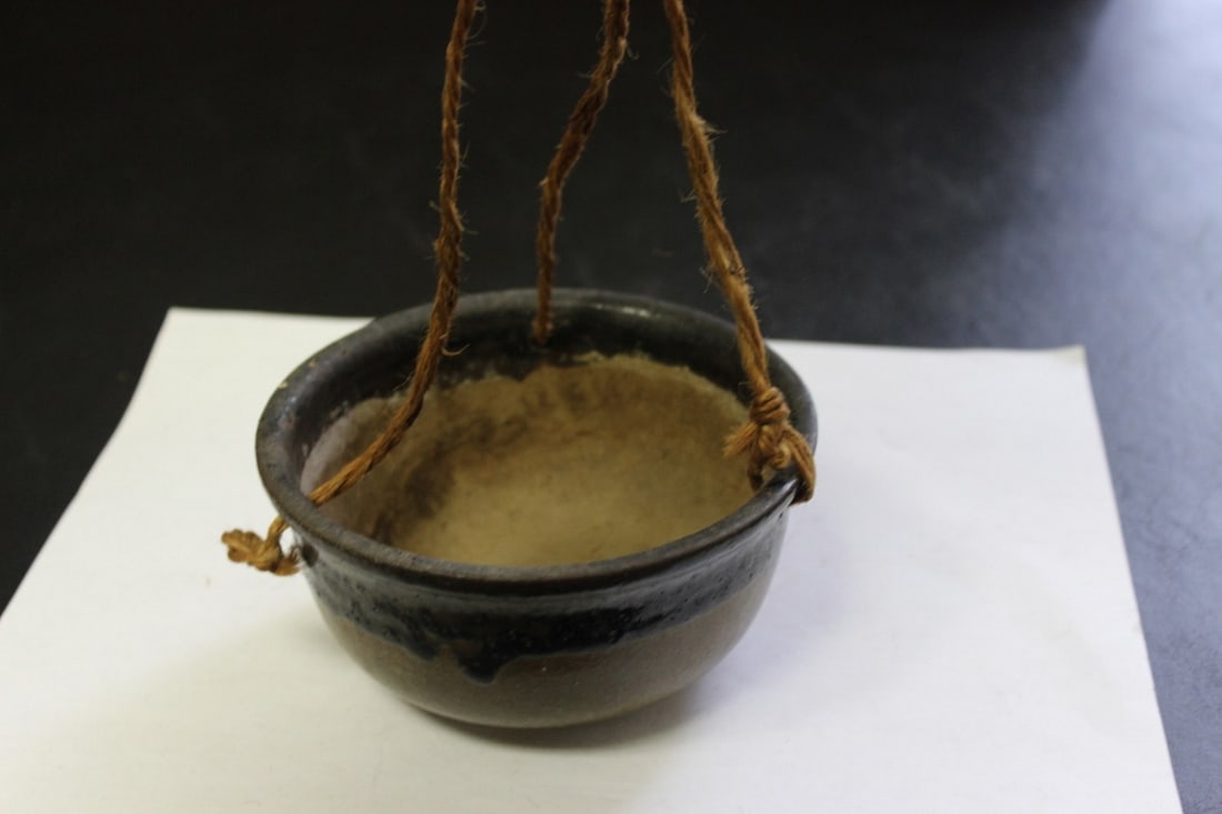 A Hanging Pottery Flower Pot:  5 inches in diameter