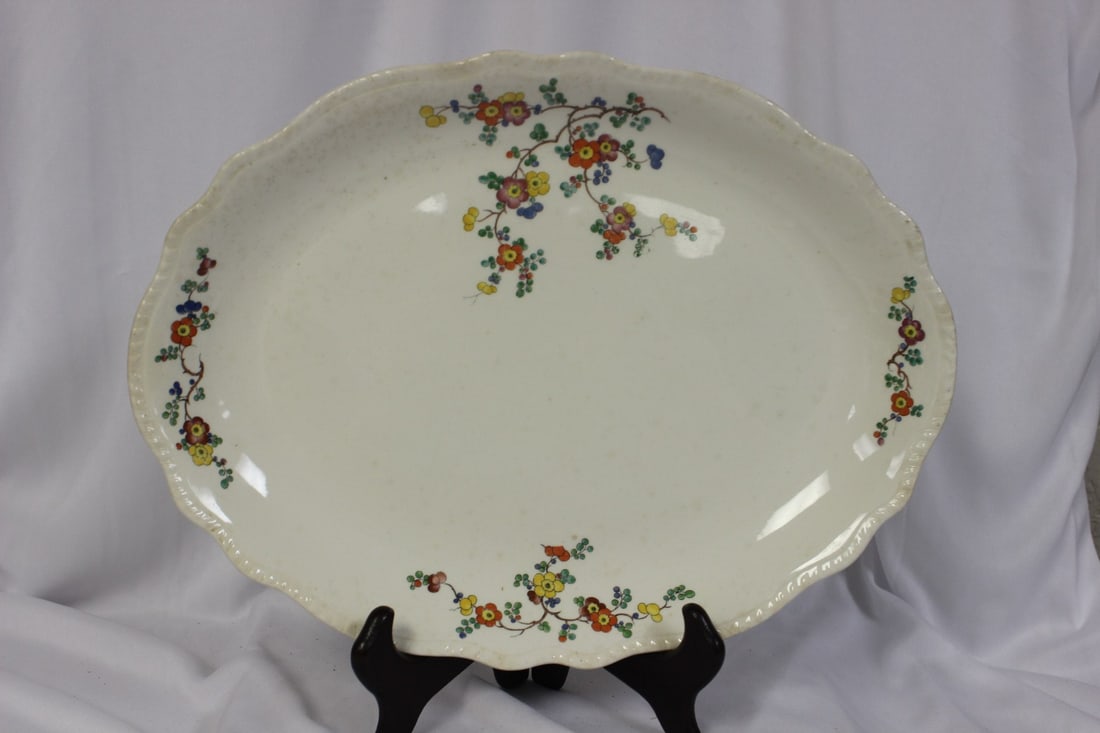 A Homer Laughlin Ovela Plate: 13 1/4" in diameter