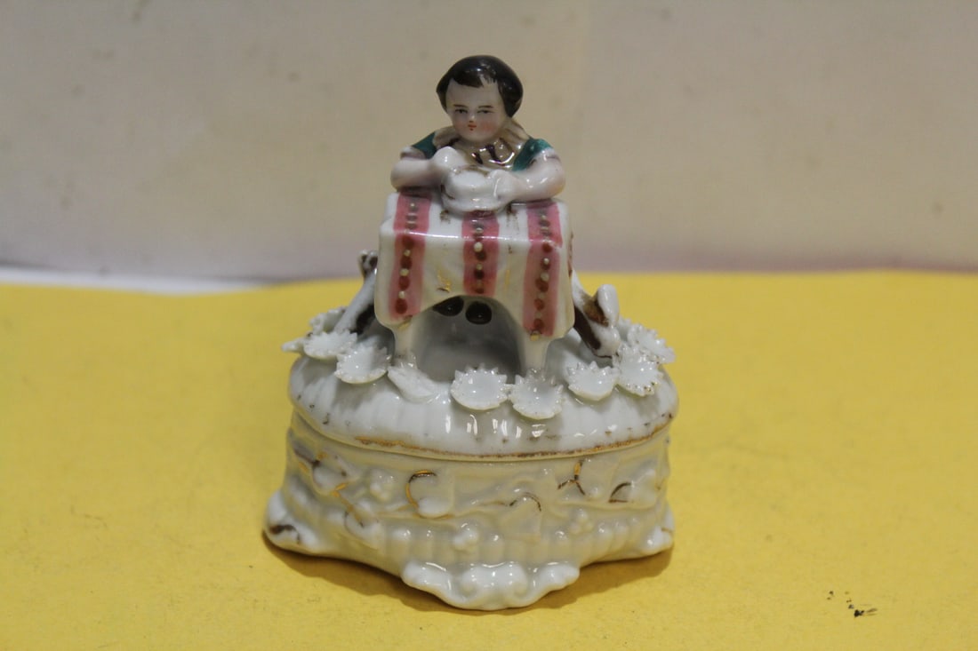 An Antique Ceramic Trinket Box: please note: some of the flowers have chips as shown - 2 1/2" across