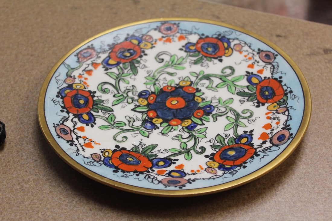 An Enamel Plate: 7 3/4" in diameter - art work on both sides