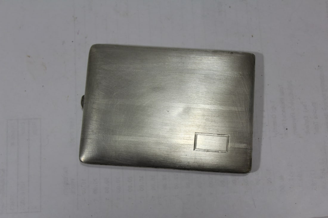 A Sterling Cigarette Case: most likely Art Deco period - 4" across