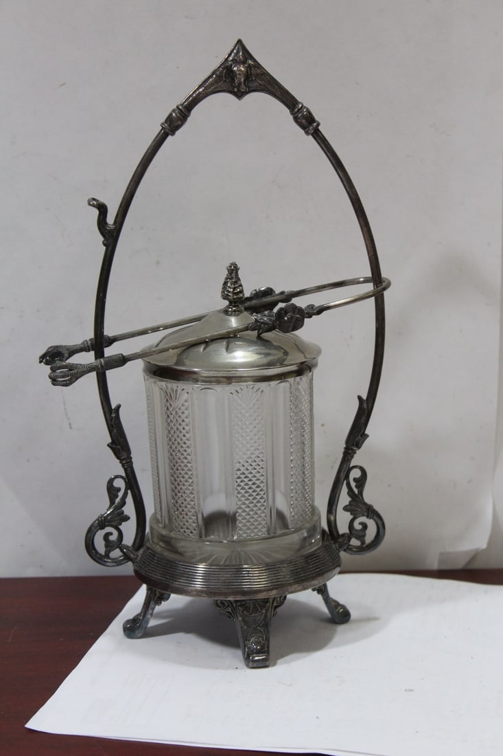 A Silverplated Pickle Castor: with tong - 11 1/2" long - please note: one underchip on the glass as shown