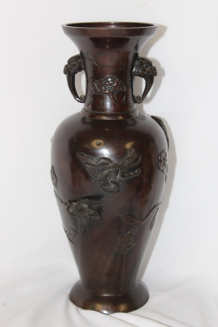 An Antique Chinese/Japanese/Asian Bronze Vase: Raised bird, 3 dimensional design - there is a small dink - possibly a manufacturer defect as shown, hardly noticeable - 9 3/4" tall