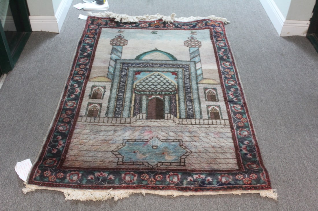 An Oriental Rug: 63" x 43" - not including the fringes - nice looking rug