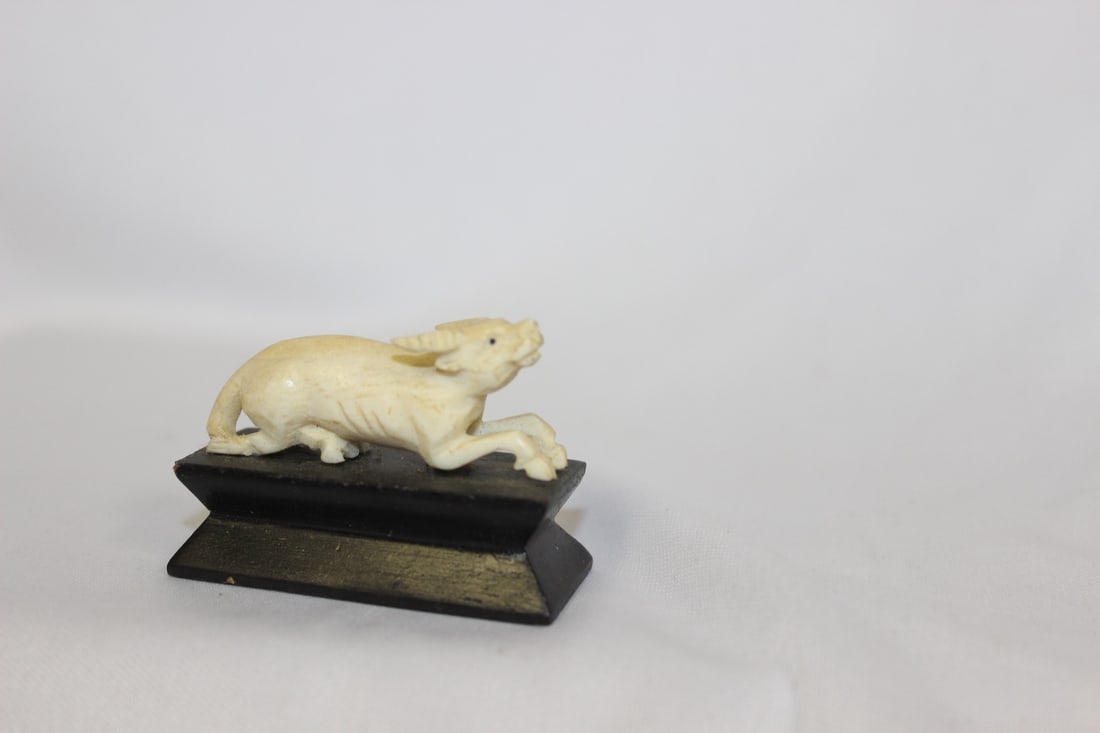 A Carved Oc on Stand: overall= 2 1/8" across