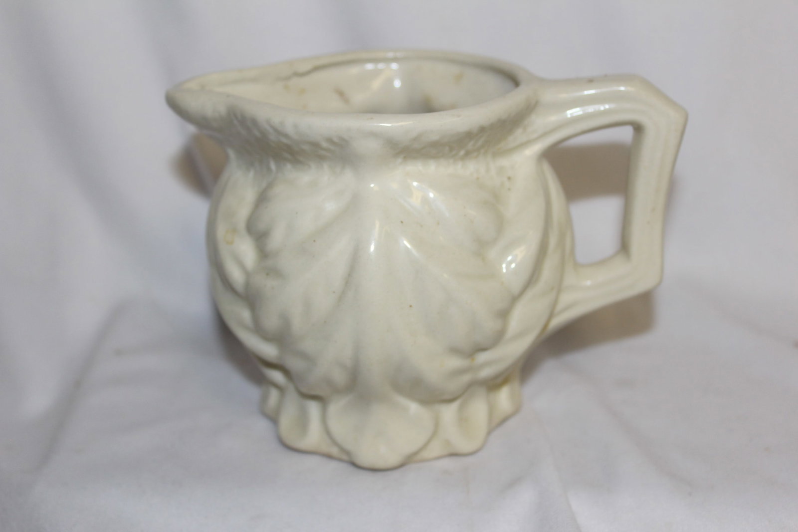 A Shawnee Pottery Pitcher: please note= manufacturer's defect on the spout - 5 5/8" across