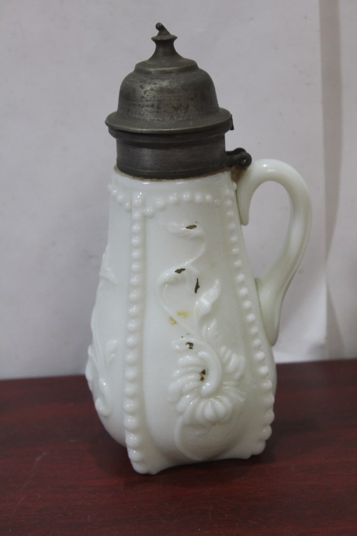 A Milk Glass Pitcher: 7 3/4" tall