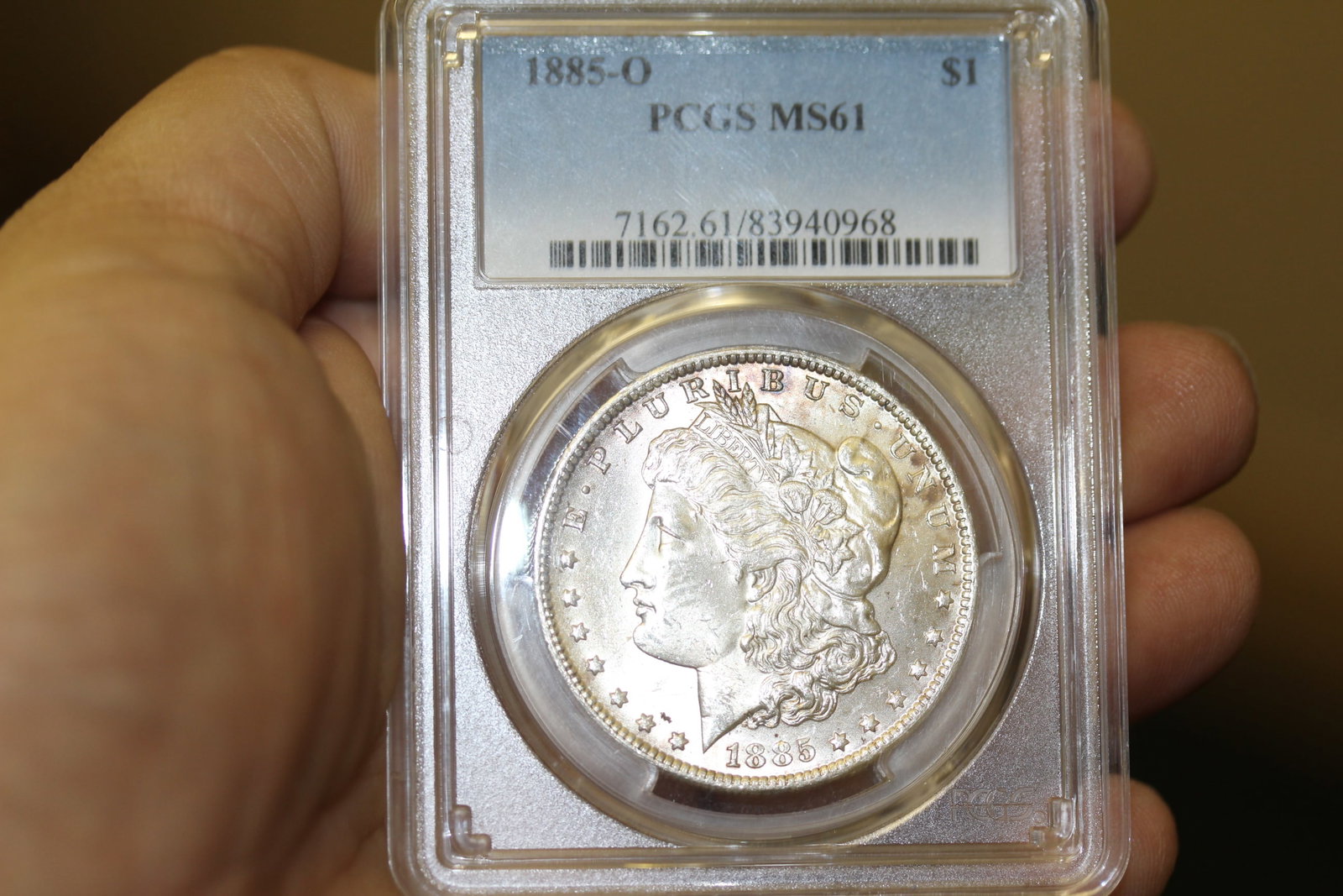 A PCGS Graded 1885-O Morgan Silver Dollar: toned - MS61
