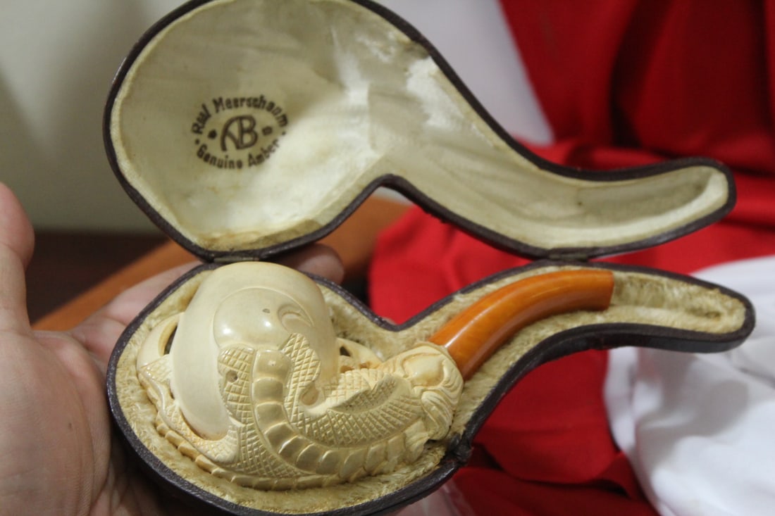 A Meerschaum Tobacco Pipe with Leather Case: well carved