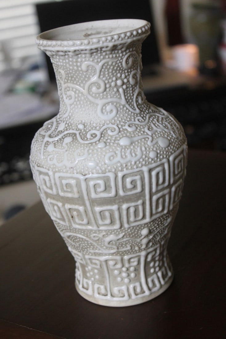 Antique Chinese Reposee Blanc de Chine Vase: Circa 19th century, possibly older - 8" tall - Very unusual piece - Three hair line cracks on the interior (pictured). Base is unglazed.