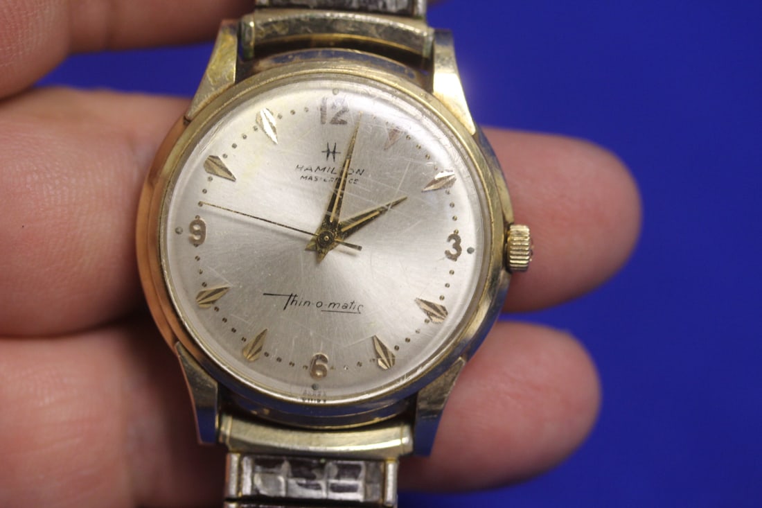 A 14 Karat Gold White Hamilton Thin-O-Matic Watch: bracelet is not gold - case is gold - currently running