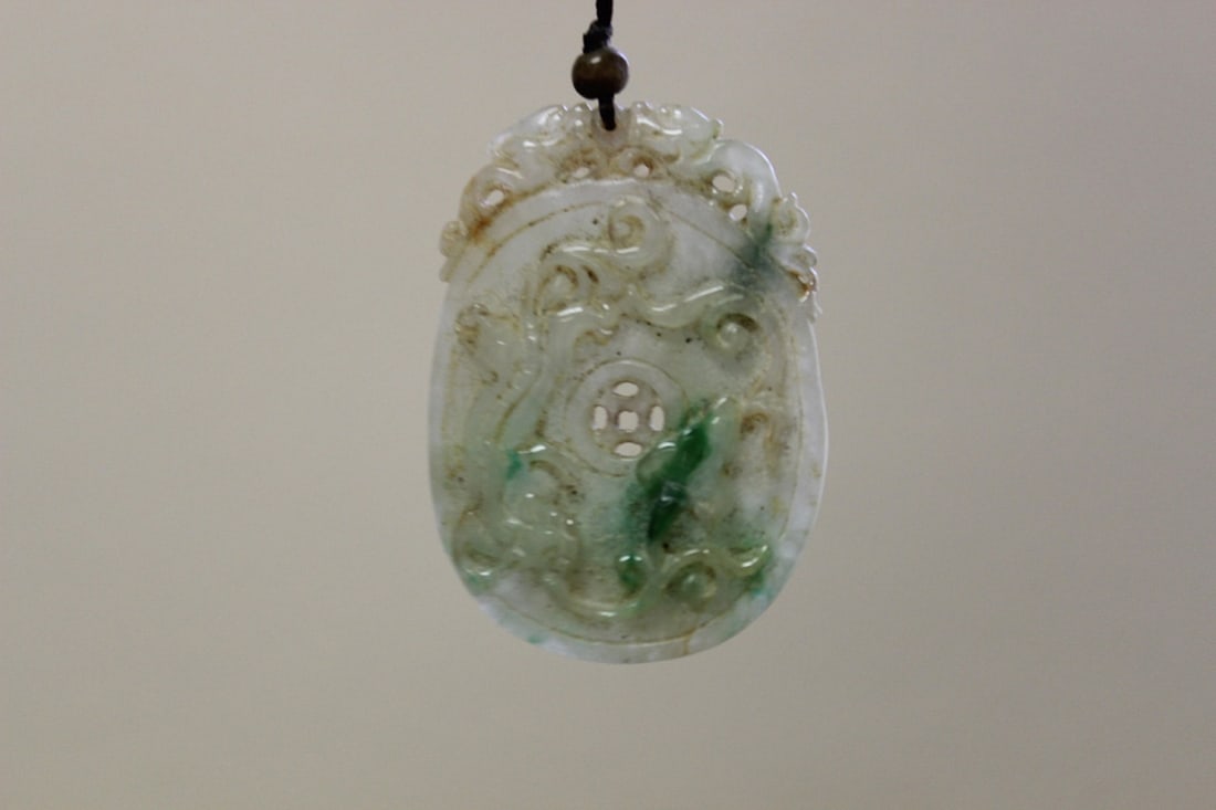 Jadeite Pendant: Exact age unknown, probably has some age. Carved on both sides. Measures 2 1/4: in diameter.