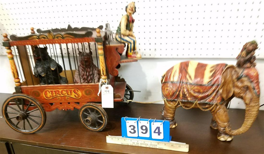 WOODEN AND METAL CIRCUS WAGON 17"H X 22"W X 12"D BY A RESIN ELEPHANT 14 1/2"H X 14"L W/ CLOWN DRIVER (1 of 3)