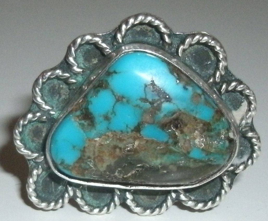Vintage Sterling Turquoise Native American SW Ring: vintage, Southwest, Native American, sterling silver and turquoise ring with decorative "rope turned" flower petal decoration surrounding the stone.The ring is a size 6 1/2 and weighs 7.8 grams.MEASUR