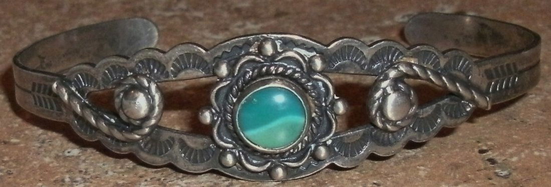 Vintage SW Native American Sterling Bracelet Engraved: sterling silver, South West, Native American Bracelet with a single multi-color stone.The bracelet is stamped "sterling" and also has other stamped sybols, which I can't make out.The bracelet is decor