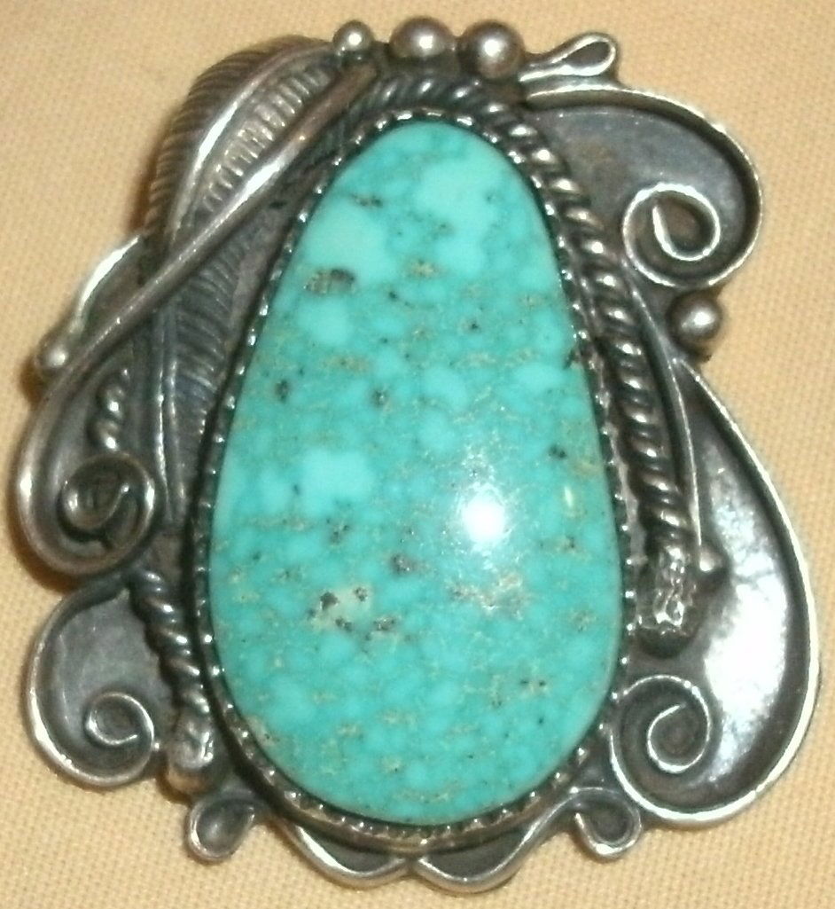 Vintage Silver Turquoise SW Native American: silver and turquoise Southwest Navajo pendant.The pendant is ornamented with leaf, rope and scroll work.It includes a beautiful polished convex Cabochon stone.The piece is signed / marked on the back