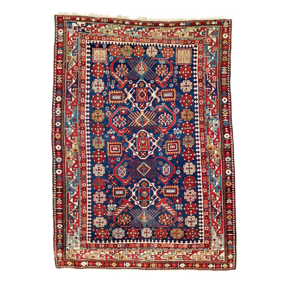 Shirvan: Second half 19th century, 162 x 118 cm, East Caucasus A design of abstract animals ascends along the central axis of the midnight blue field, surrounded by Talish rosettes. The main border shows the z