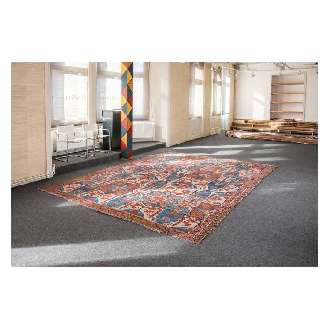 Bakhshaish: Mid 19th century, 430 x 320 cm, North West Persia, Azerbaijan The rare repeat of blue cypresses, red and blue cartouches with a cruciform, floral interior design and palmettes of feathered appearance