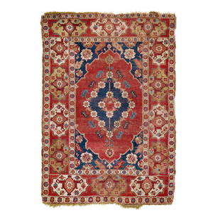 Double Niche Carpet: Second half 17th century, 175 x 127 cm, West Anatolia, Manisa Province This red-ground double niche carpet of the Transylvanian group presents a floral blue-ground central medallion and a cartouche bo