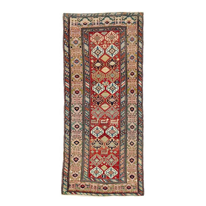 Shirvan: Mid 19th century, 230 x 106 cm, East Caucasus The light red field is decorated with a two-row repeat of octagons enclosing a large hooked diamond, with smaller designs and animals placed between them.