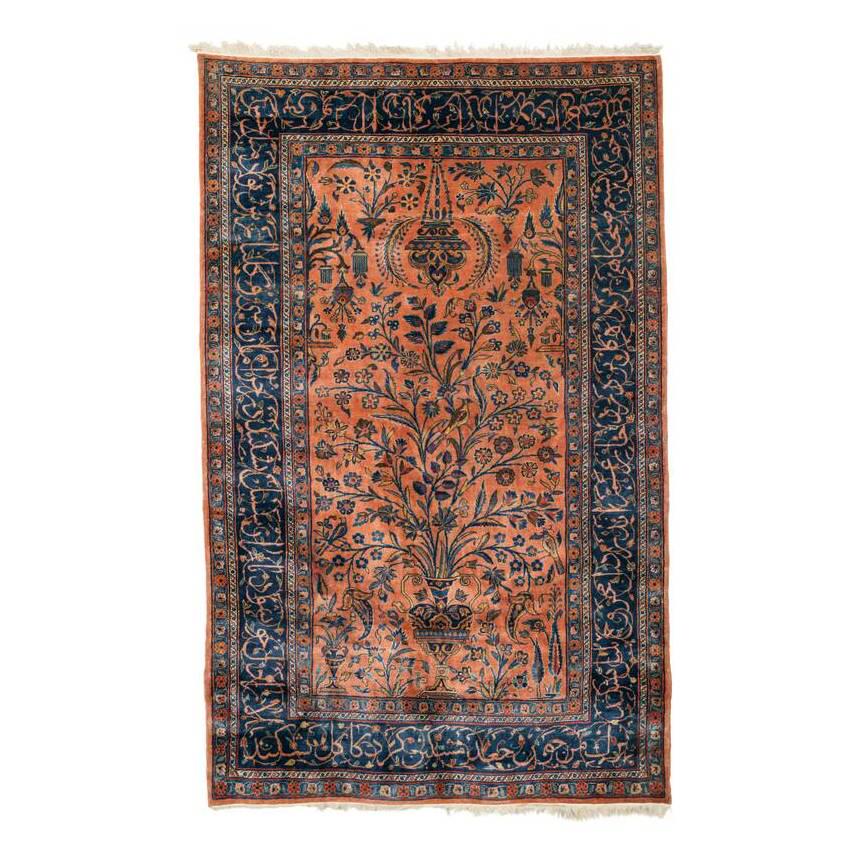 Kashan: Second quarter 20th century, 200 x 126 cm, Central Persia A tree grows from a large vase placed at the lower end of the salmon field, its flowering branches sweeping upwards as far as the mosque lamp 