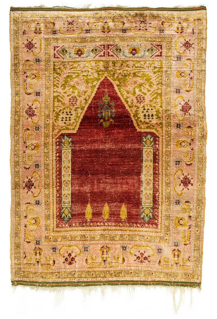 Silk Panderma Prayer Rug: First quarter 20th century, 151 x 104 cm, North West Anatolia Obvious signs of age and wear, low pile, minor repairs, tear in the upper right corner, original finishes all around.