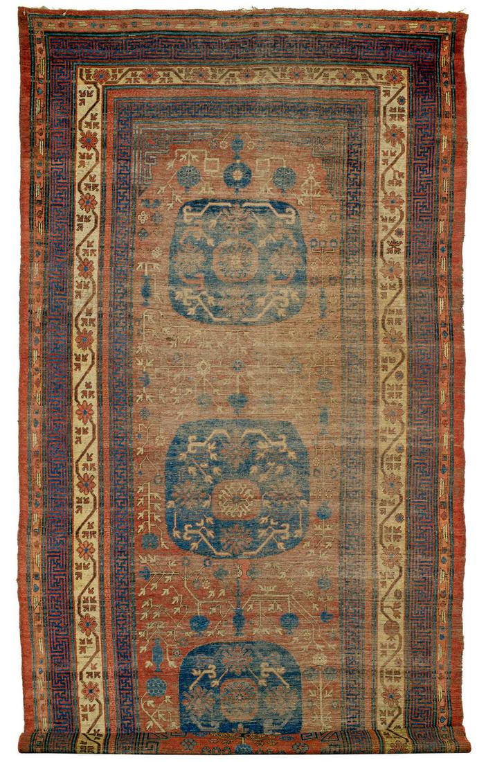 Khotan: first half 19th century, 482 x 204 cm, Central Asia, East Turkestan Heavily worn. Sides damaged. Finishes reduced. 