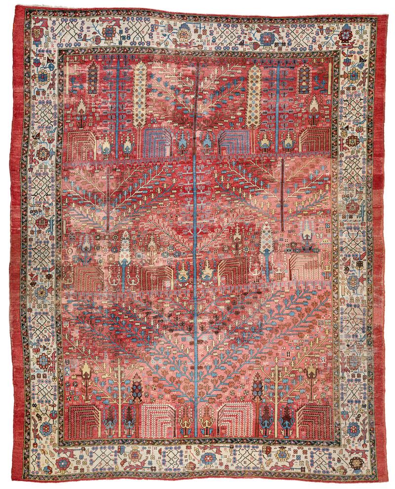 Bakhshaish: late 19th century, 350 x 285 cm, North West Persia, Azerbaijan A large red-ground Bakhshaish garden carpet. A blue tree with sprawling branches extending across the whole length of the field constitut
