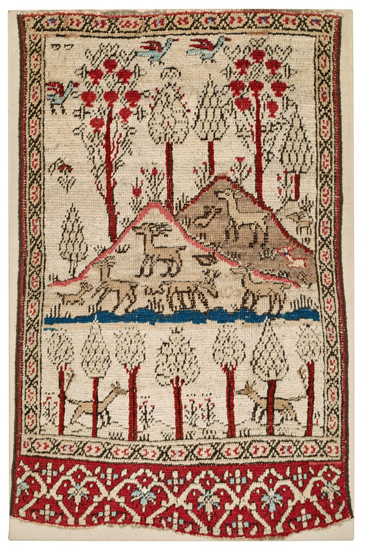 Bakhshaish Landscape Rug: second half 19th century, 83 x 50 cm, North West Persia, Azerbaijan A white-ground Bakhshaish landscape rug woven in a very rare miniature format. In the lower section of the field, seven slender tree
