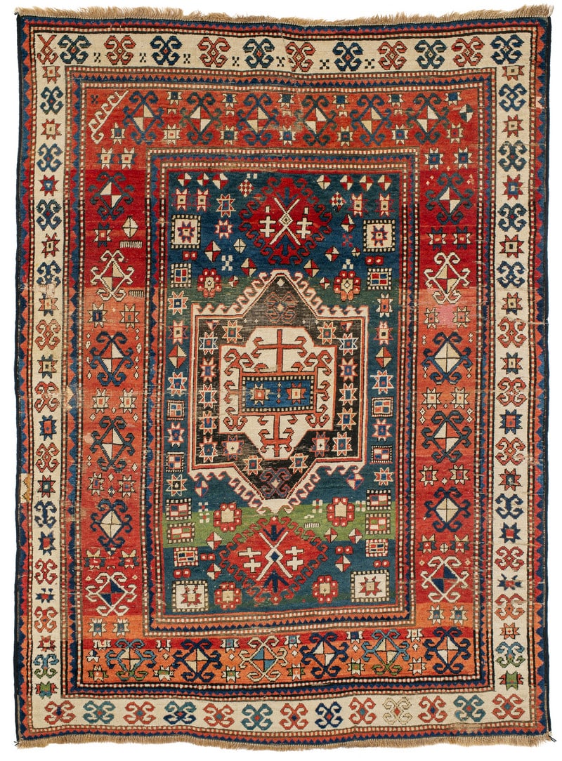 Kazak: circa 1880, 221 x 166 cm, South West Caucasus, Armenia Obvious signs of age and wear. Various repairs. Corroded brown sections. A horizontal stiched tear in the upper border area. Cut sides, replaced