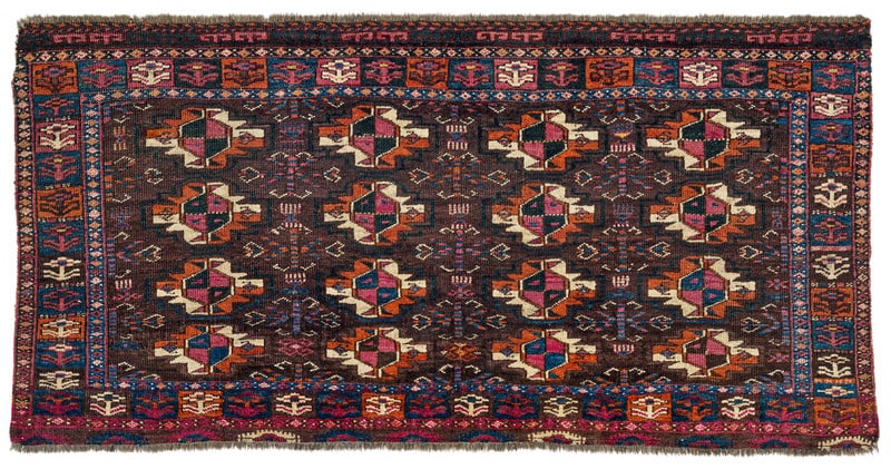 Arabachi Chuval: mid 19th century, 70 x 142 cm, Central Asia, West Turkestan Sixteen chuval guls and chemche secondary guls adorn the field. The main border design of flowering plants within rectangular compartments i