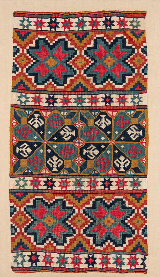 Stoldyna: ca. 1800, 99 x 56 cm, South Sweden, Skane, Ingelstad District The face of a yellow-ground seat cushion woven in the rollakan technique. The upper and lower horizontal stripes each comprise two large