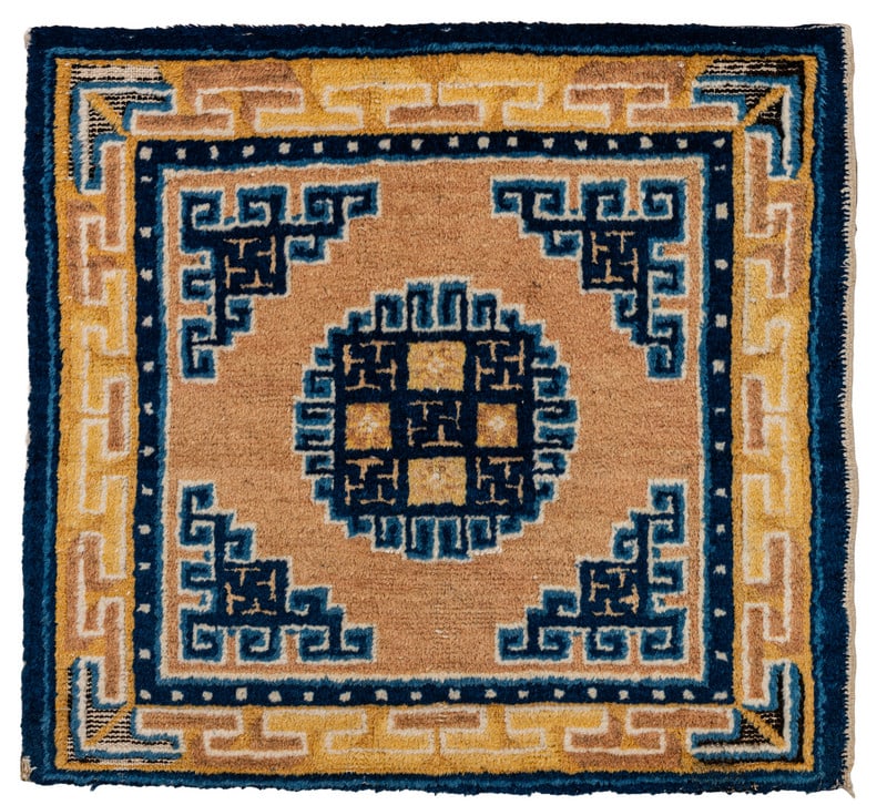 Ningxia Seat Mat: early 19th century, 67 x 69 cm, West China This seat mat shows a disc medallion in the open field and abstracted geometric dragon figures in the corners. The main border features a meandering vine
