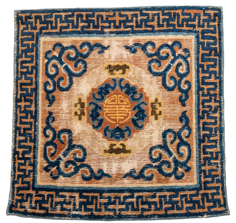 Ningxia Seat Mat: mid 18th century, 73 x 73 cm, West China This seat mat was woven in the mid 18th century, i.e. during the reign of the Qianlong Emperor (1736–1795). At the centre of the heavily corroded field, a