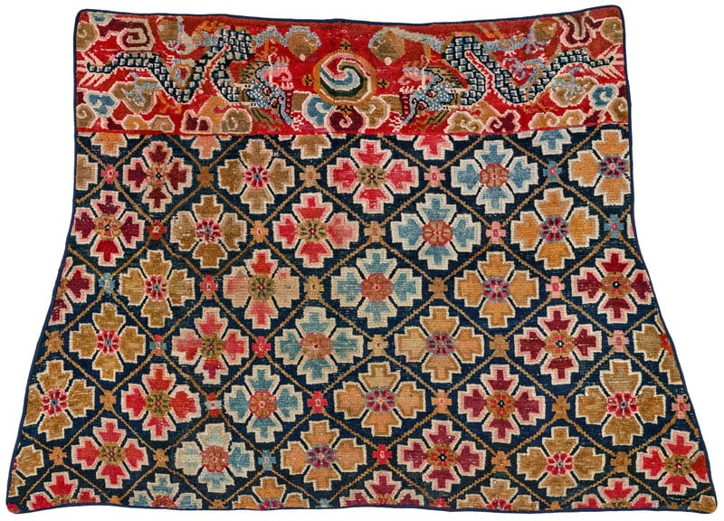 Gyantse Horse Cover: ca. 1900, 123 x 185 cm, Central Asia, South Tibet These trapezoid Tibetan horse covers are known as "takheb" in their country of origin. A wide design stripe at the upper end depicts two dragons
