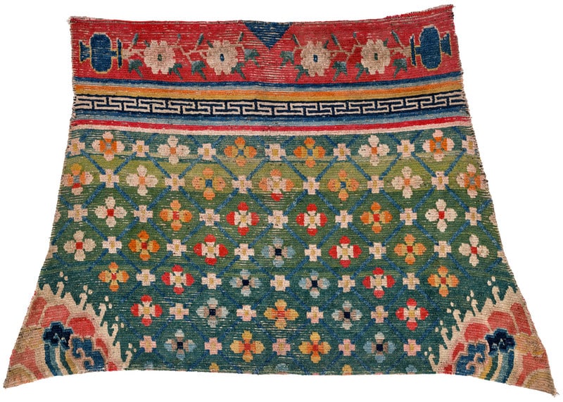 Gyantse Horse Cover: ca. 1900, 94 x 151 cm, Central Asia, South Tibet A horse cover with an arc-shaped lower end and pointed corners. In the green field, a light blue diamond lattice encloses small polychrome rosettes