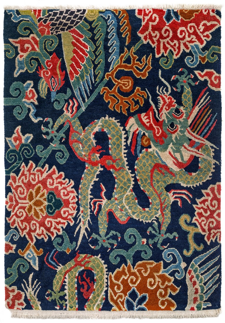 Gyantse Jabuye: ca. 1900, 82 x 54 cm, Central Asia, South Tibet A large green dragon chasing the flaming pearl fills the upper half of the dark blue field. A second dragon appears at the bottom right, although only