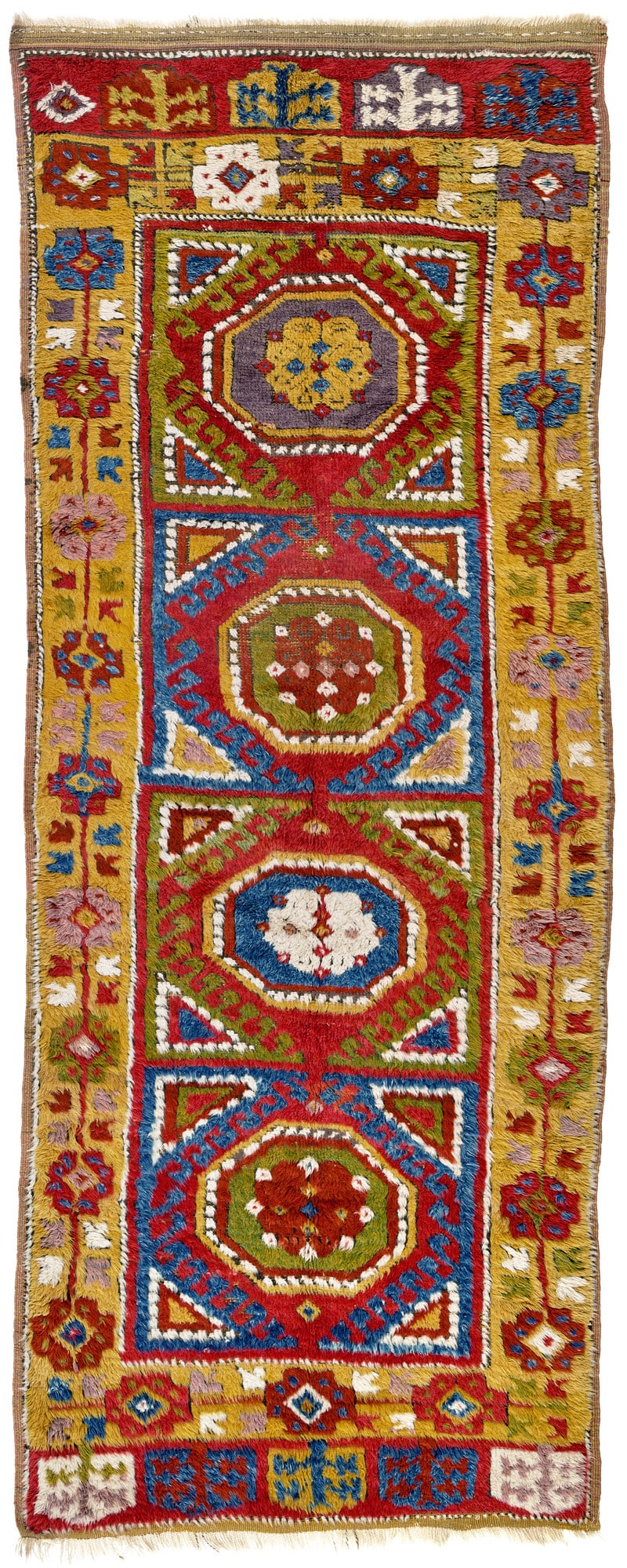 Incesu: first half 19th century, 296 x 116 cm, Central Anatolia, Kayseri Four massive box shapes in blue and green fill the field of this Incesu long rug to such an extent that almost nothing of the red