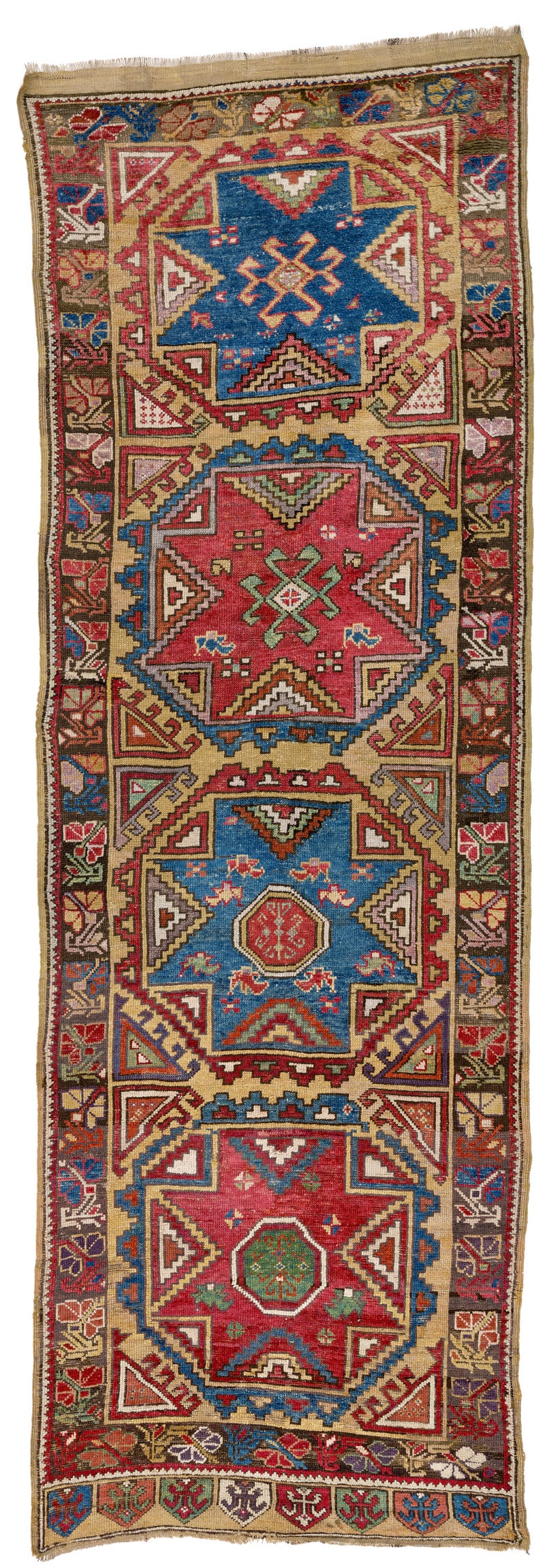 Obruk Long Rug: first half 19th century, 258 x 116 cm, Central Anatolia, Konya Four large eight-pointed star devices within octagonal surrounds with stepped outlines fill the yellow field. Each of these primary