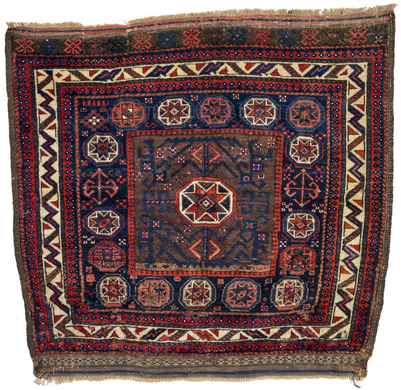 Baluch Bag Face: third quarter 19th century, 93 x 85 cm, North East Persia, Khorasan In this large Baluch bag face, the steel blue central field shows a design of eight-pointed stars within octagonal surrounds. A