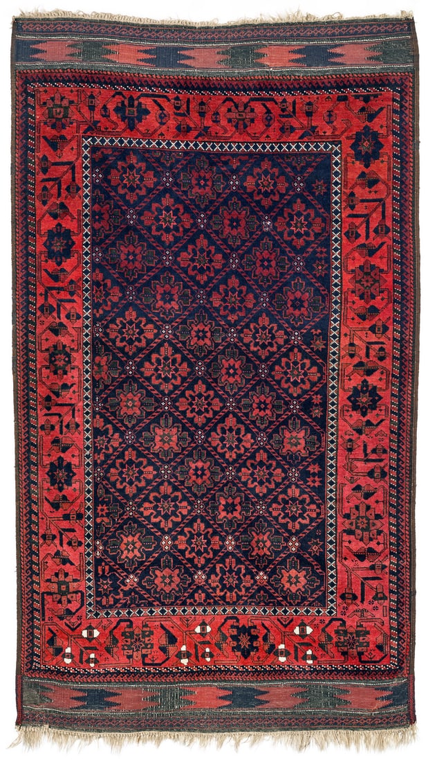 Baluch: second half 19th century, 196 x 108 cm, North East Persia, Khorasan, Torbat-e Haydari The steel blue field is covered in a diamond lattice design that encloses large star-shaped blossoms. The wide