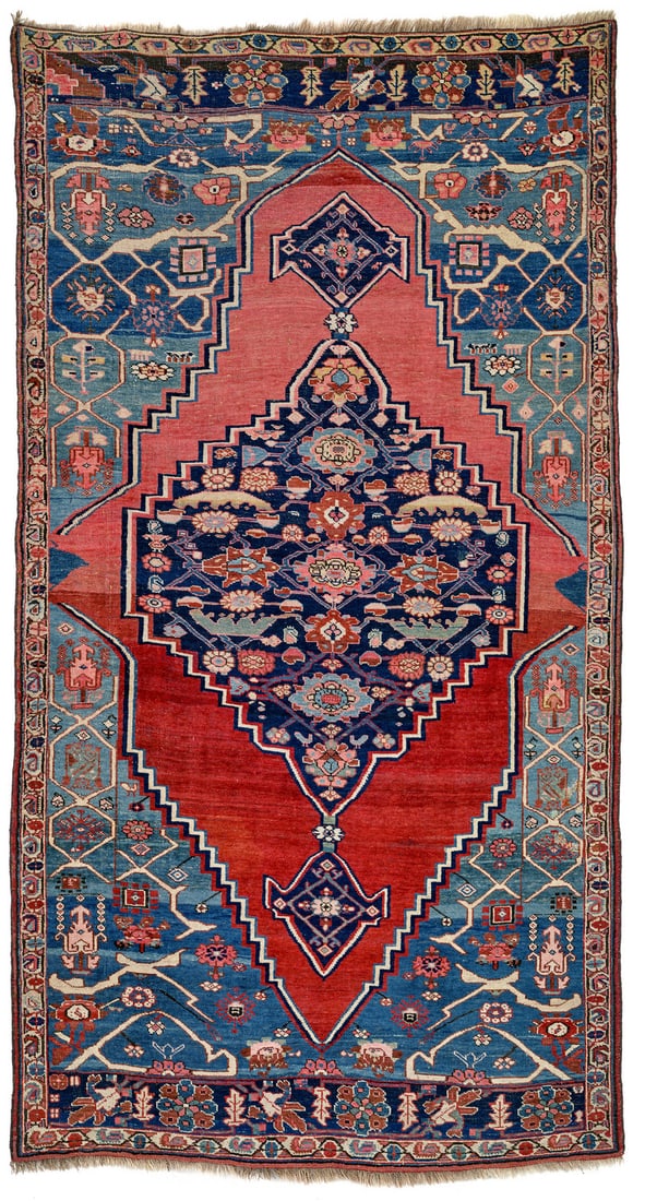 Bijar Vagireh: late 19th century, 261 x 140 cm, North West Persia, Kurdistan The shield-shaped red field contains a dark blue, hexagonal central medallion with pendants that has been shifted to the right. The oversi