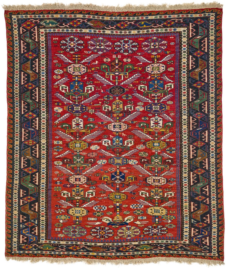 Kuba Sumakh: mid 19th century, 176 x 155 cm, East Caucasus This small-format red-ground sumakh displays a rare design of trees placed in three offset rows. Their diagonal white leaves look like the wings of