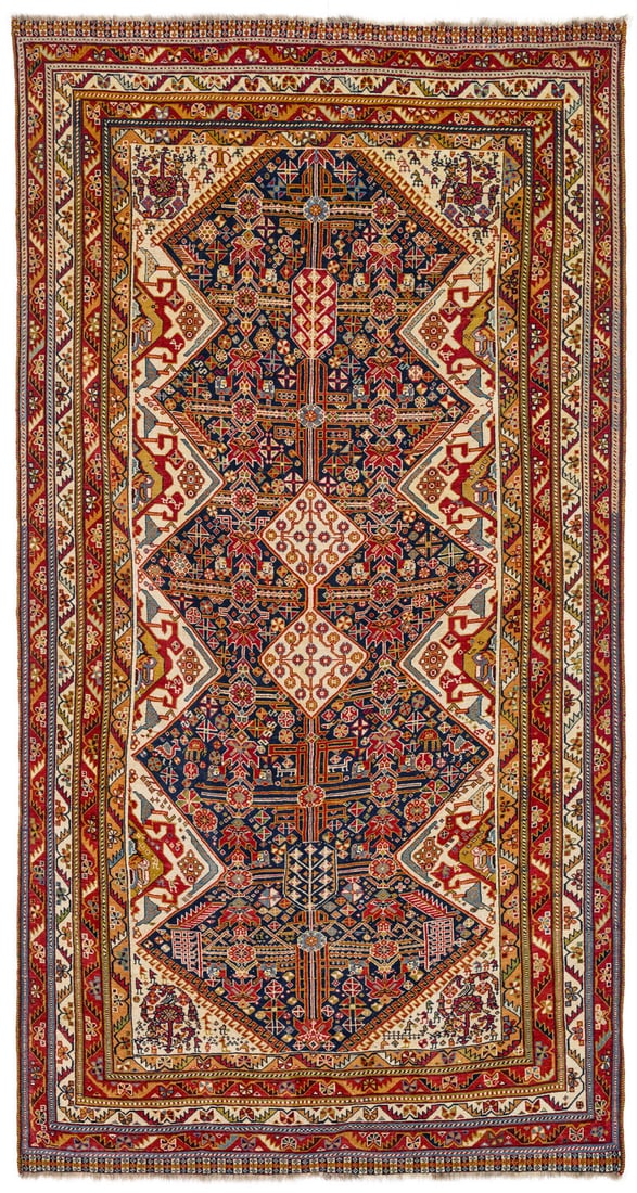 Qashqai: late 19th century, 281 x 145 cm, South West Persia, Fars The dark blue field, with two diamonds and tree forms aligned on its central axis, has a serrated outline created by white diamond halves that 